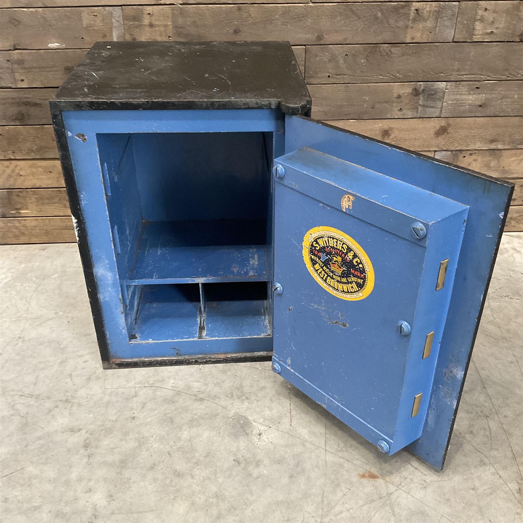 Samuel Withers & Co of West Bromwich - Victorian cast iron safe, the brass handle modelled as a clenched fist, painted in red, orange and black, with key. Ground floor delivery only, no steps.