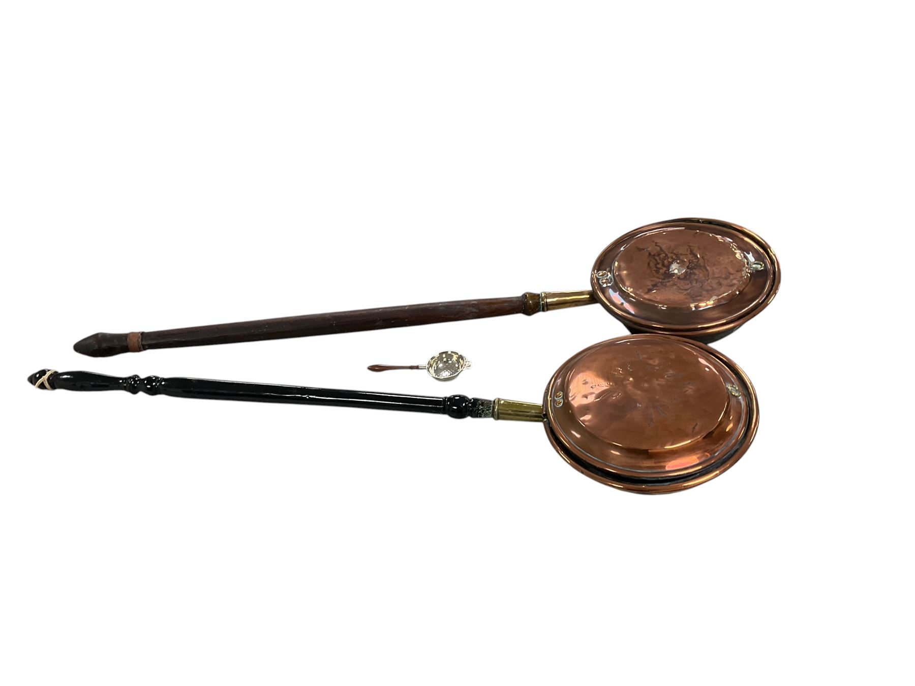 Two copper warming pans with silver strainer
