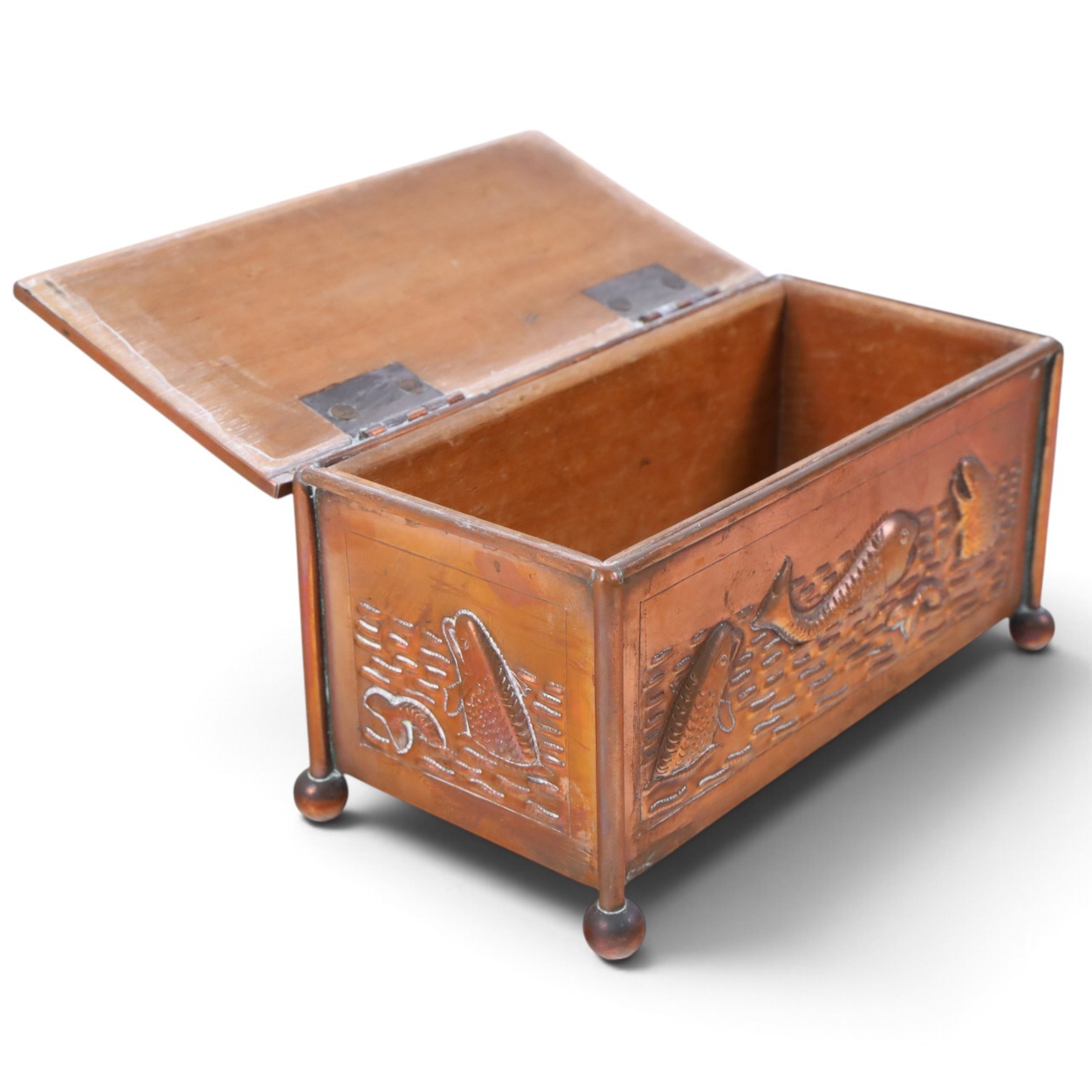 Art and Crafts copper and brass hammered casket, of rectangular form with repoussé decoration of dolphins, in the manner of  John Pearson, H10cm L19cm