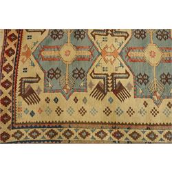 Two Caucasian designed rugs comprising a flatweave and hand-knotted rug, Caucasian design flatweave, cream ground with three large blue geometric medallions surrounded by stylised birds and geometric motifs, enclosed by repeating geometric border, fringed ends, H176cm, W102cm; hand-knotted Caucasian rug, ivory ground with three polychrome octagonal medallions surrounded by stylised animals, flowerheads and geometric motifs, enclosed by salmon pink geometric border, fringed ends, H163cm, W106cm