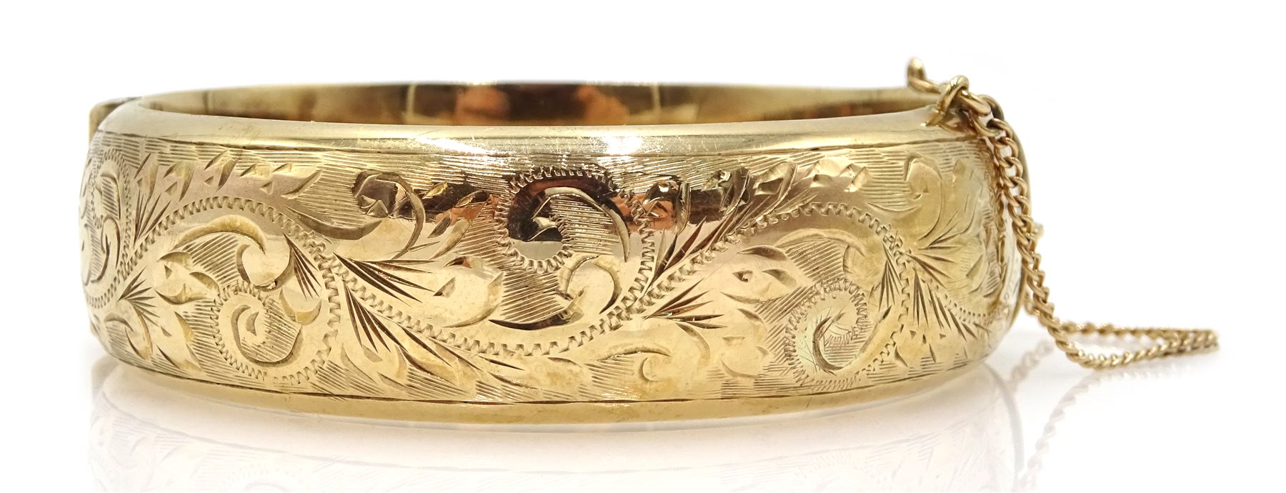 9ct gold bangle with engraved decoration, Birmingham 1987, approx 30gm