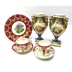 A 19th century Botanical dessert plate, possibly Ridgway, D22cm, together with a 19th century tea cup and saucer, and further cup, each decorated with panels of roses within a claret border, a New Hall type saucer, and a pair of twin handled urns in the manner of Spode, with figural winged handles and hand painted fruit panels upon a blue ground, heightened in gilt, H23cm (7)