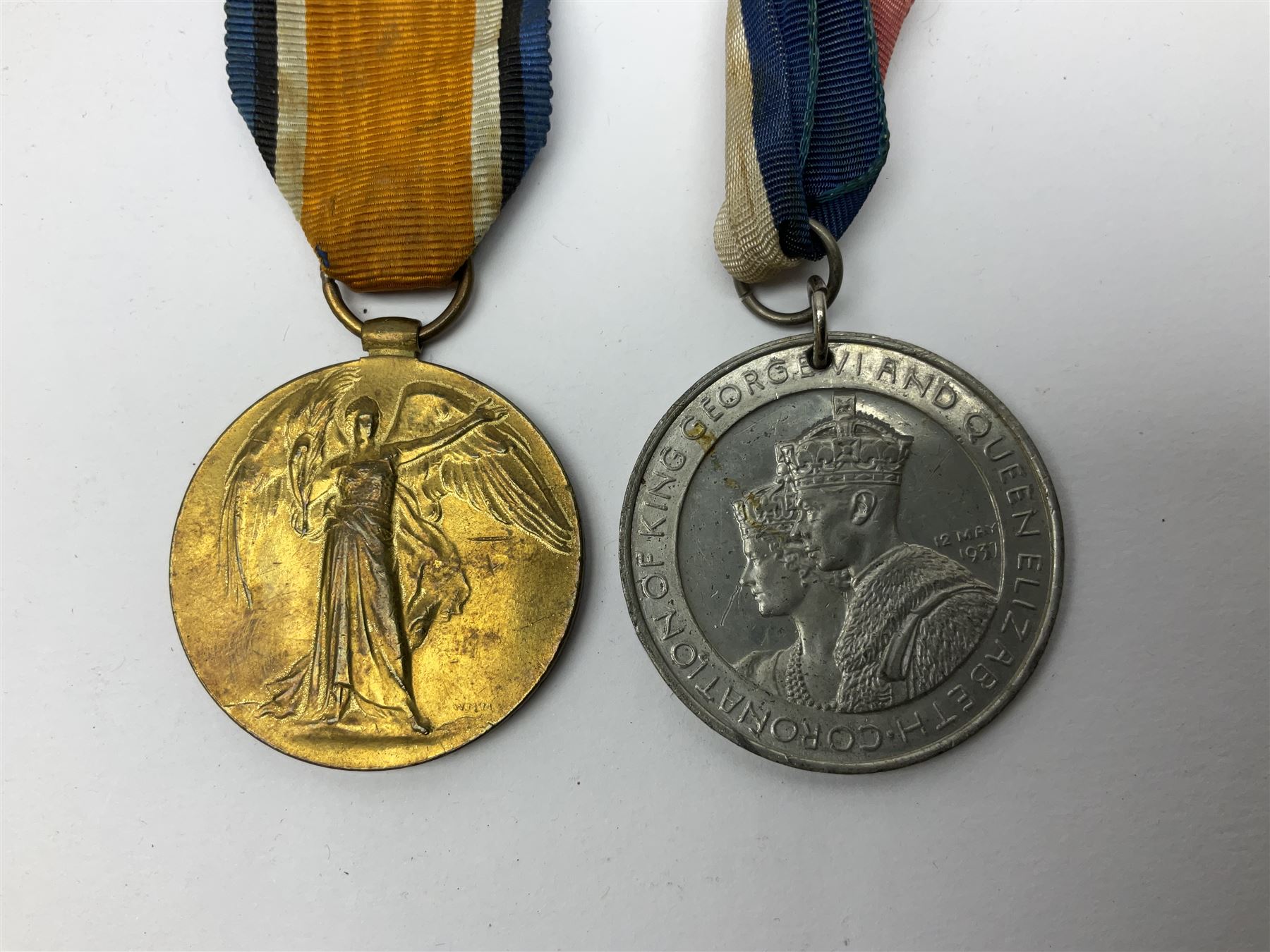 WW1 pair of medals awarded to 151761 Gnr. S. Loten R.A. with ribbons; four WW2 medals with ribbons; and small quantity of cap badges, medallions etc