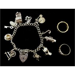Gold paste flower cluster ring and a gold stone set eternity ring, both 9ct and a silver curb link bracelet with heart padlock clasp by Georg Jensen, with ten silver charms including train, scooter and saxphone