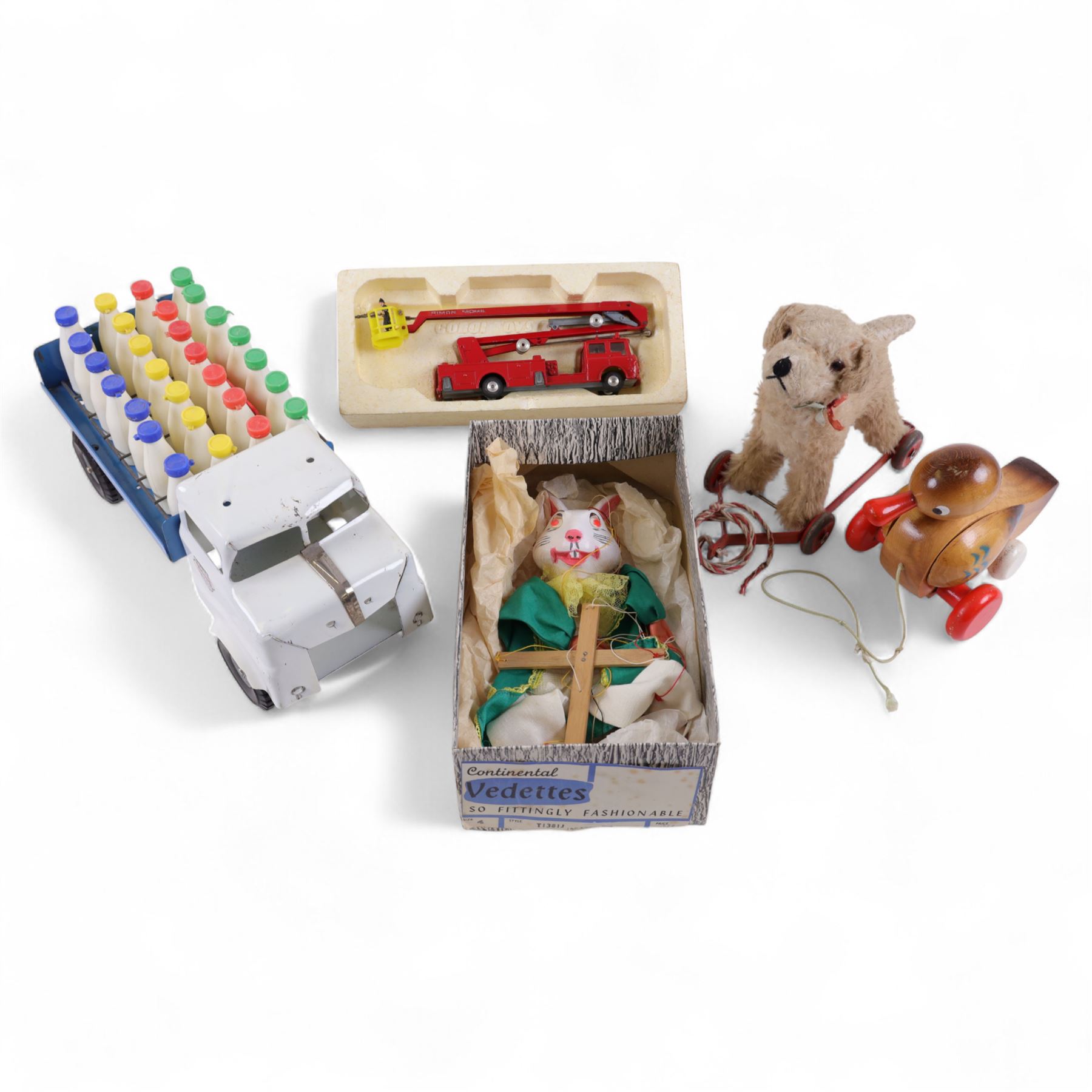 Triang pressed steel milk float with plastic bottles, together with a Pelham white rabbit puppet, wooden duck toy, pull along dog and Corgi Simon Snorkel engine