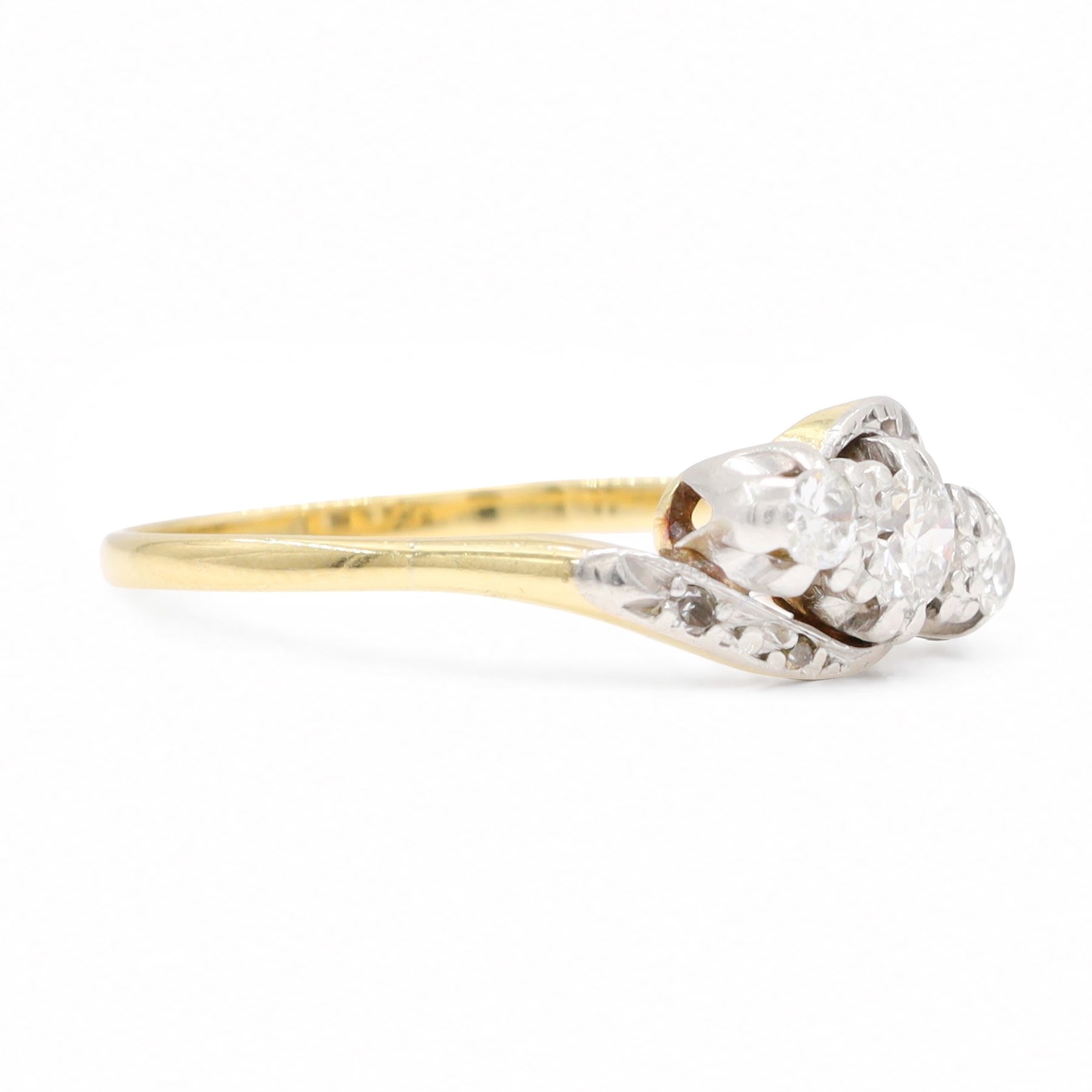 18ct gold diamond crossover ring, set with three old cut diamonds and two diamond chips either side, Birmingham 1982, total diamond weight approx 0.30 carat