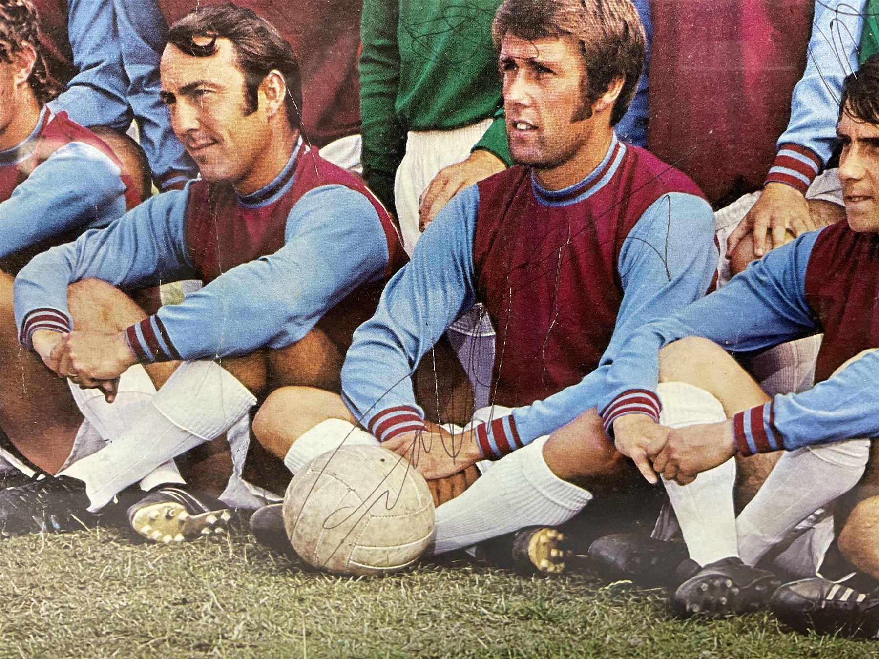 1970-1 photograph of West Ham United FC squad members, including Bobby Moore, Geoff Hurst, Harry Redknapp, Trevor Brooking, Jimmy Greaves, Billy Bonds etc, most players with signatures, 30 x 45cm, framed and glazed
