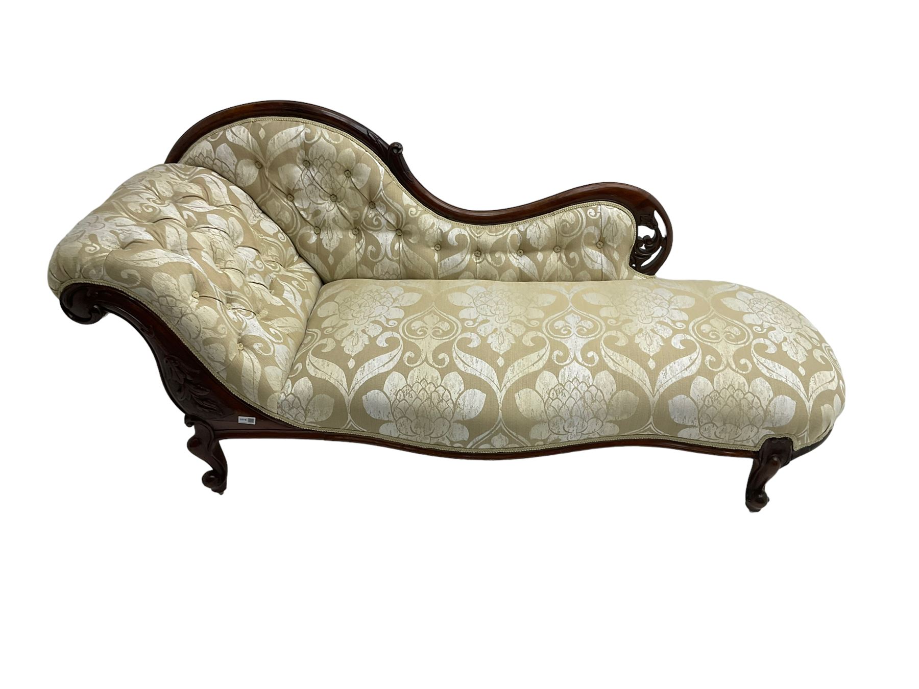 Victorian mahogany chaise longue, scrolled back with pierced and floral carved decoration, champagne foliate pattern fabric, cabriole feet with brass and ceramic castors