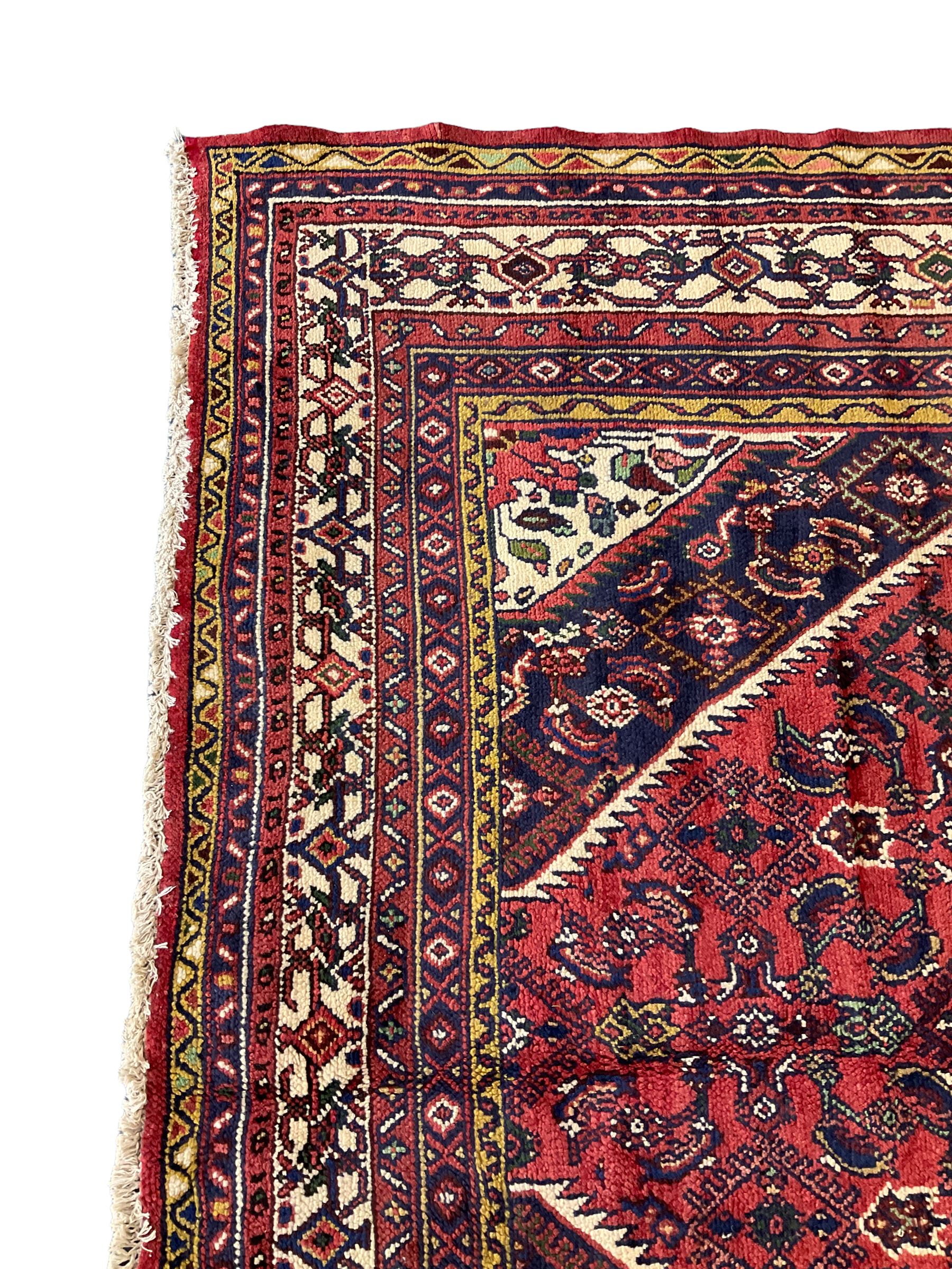 North West Persian Hamadan carpet, the extended lozenge field decorated with Herati motifs, central lozenge medallion, multiple border bands decorated with geometric designs 