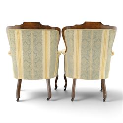 Edwardian mahogany three-piece salon suite, comprising settee and two armchairs, shaped frames with upholstered backs, scrolled arm supports and serpentine seat rails, upholstered in striped floral damask fabric, on cabriole supports with castors (Armchairs: H 96cm, W 70cm, D 68cm)