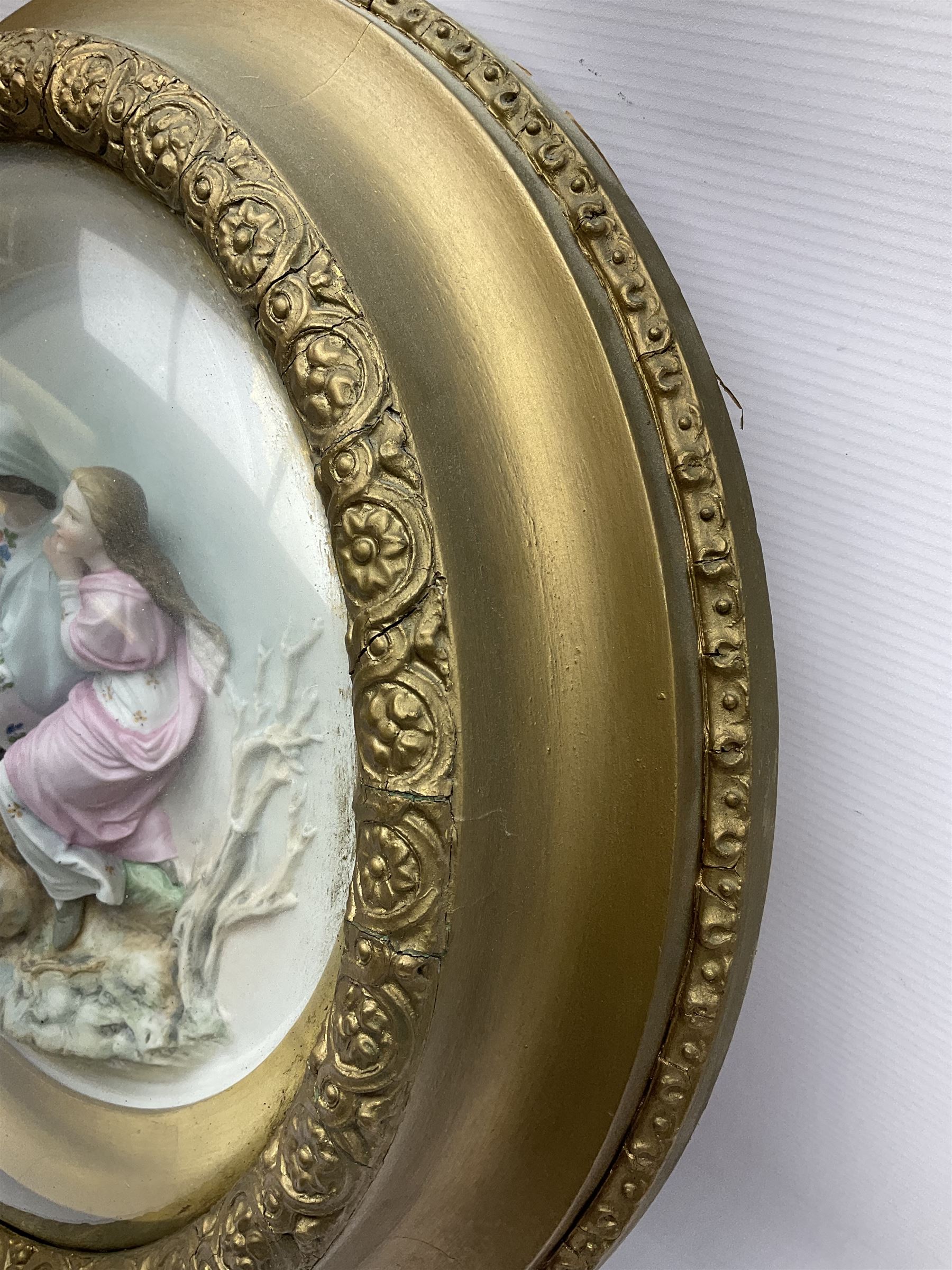 Set of four early 20th century Continental bisque plaques, each of circular form, modelled in high relief as the Four Seasons personified, within gilded circular frames under convex glass, overall D44.5cm