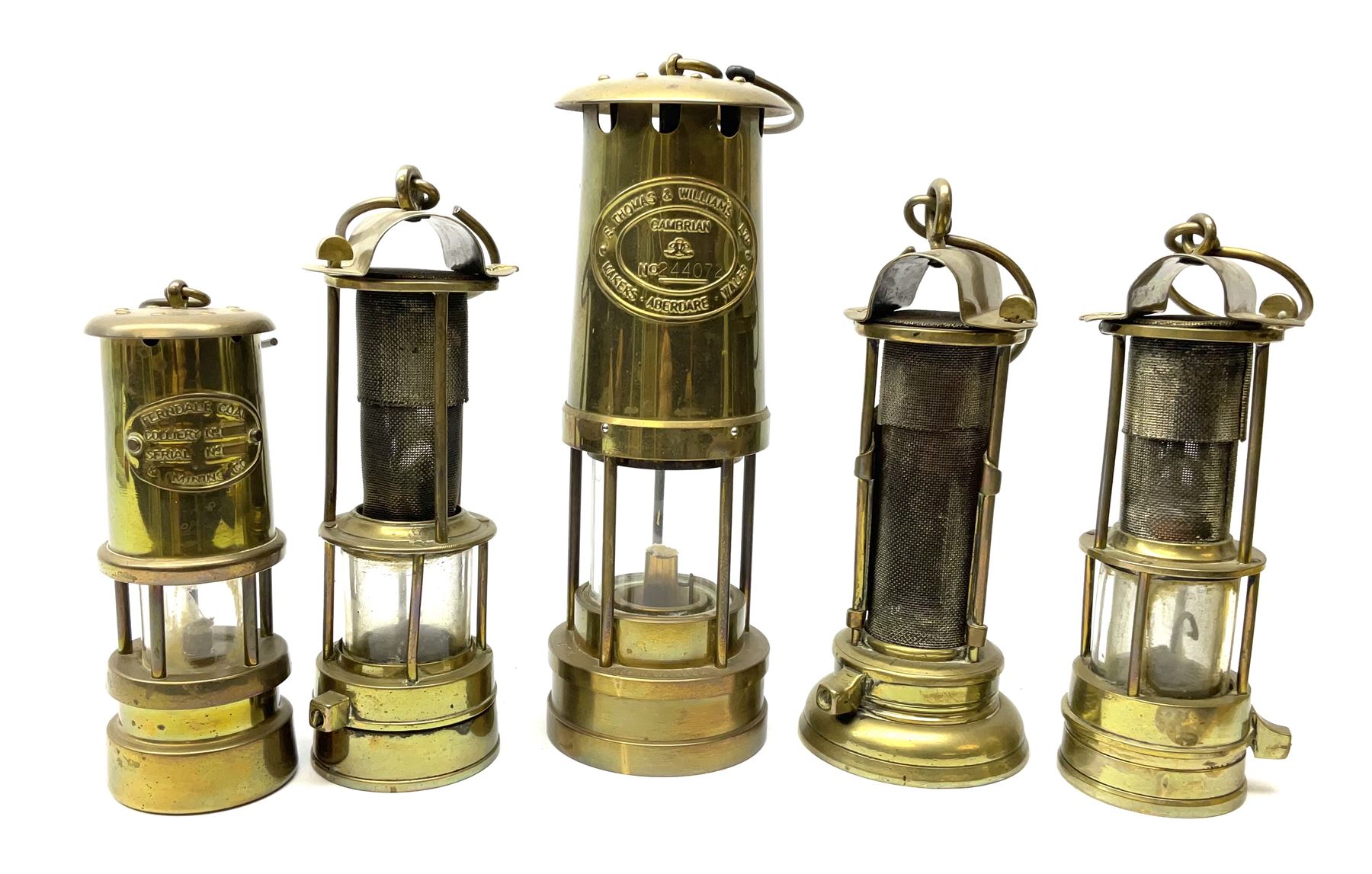 A collection of five mining lamps, to include examples by F Thomas & William Ltd, H25.5cm, Ferndale Coal, 18cm, and Daidler Durham, H21cm, plus two unmarked examples.