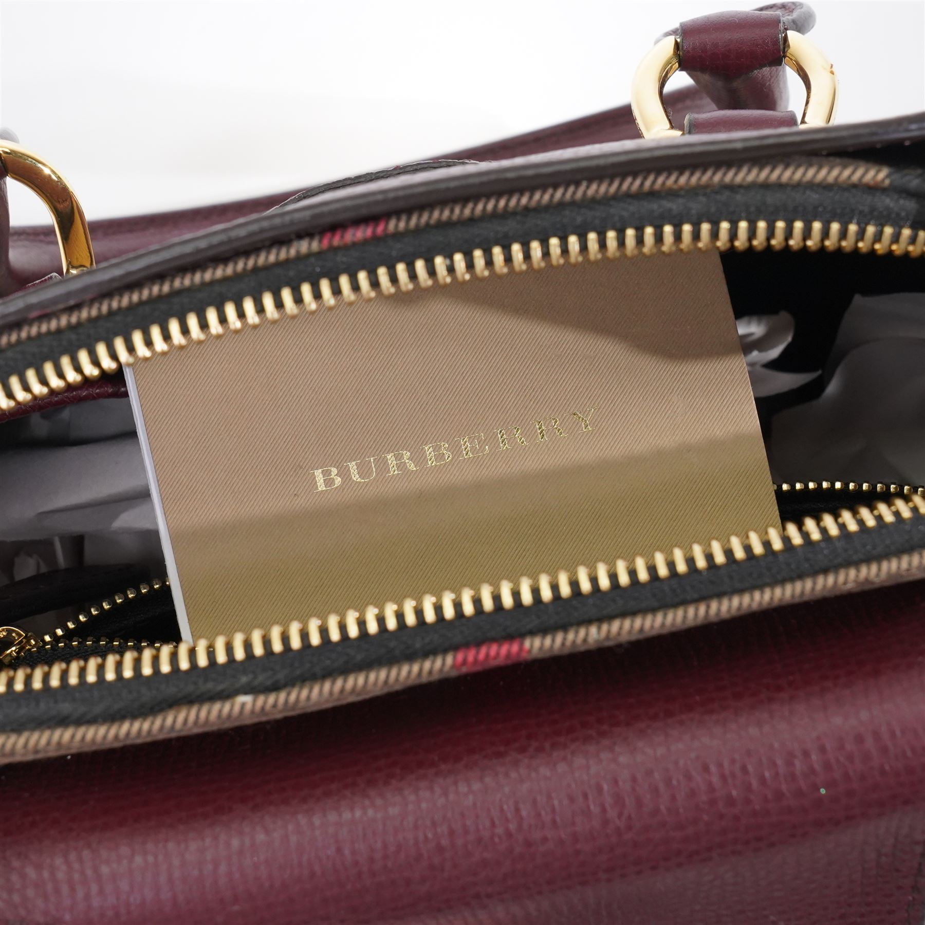 Burberry - ‘Milverton’ Small House Check Bag, introduced circa 2015 under Christopher Bailey, in signature Haymarket check canvas with oxblood grained leather trim and belted front detail, with rolled top handles and detachable shoulder or crossbody strap, with gold-tone hardware, unused with original dust bag