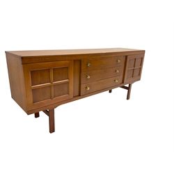Elliotts of Newbury (EoN) - mid-20th century teak sideboard, fitted with three central drawers flanked by two cupboards, raised on square supports 