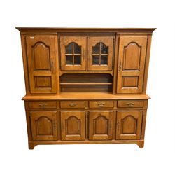 Barker and Stonehouse - oak dresser, the raised back fitted with glazed display cabinet and cupboards, the lower section fitted with drawers and cupboards, panelled doors