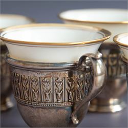 Set of six Lenox porcelain coffee cups, with gilt rims, each with American silver openwork cup holders, stamped sterling