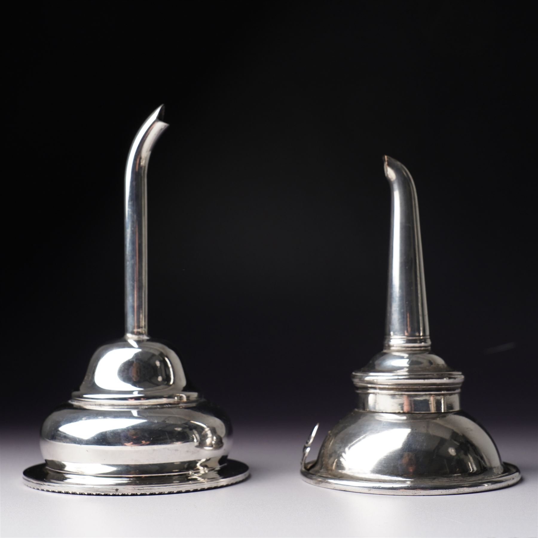 18th century Sheffield plate wine funnel by Roberts, Cadman & Co with bell mark, two other plated wine funnels and a Victorian plated bottle coaster by Elkington & Co with pierced decoration and turned wooden base (4) 