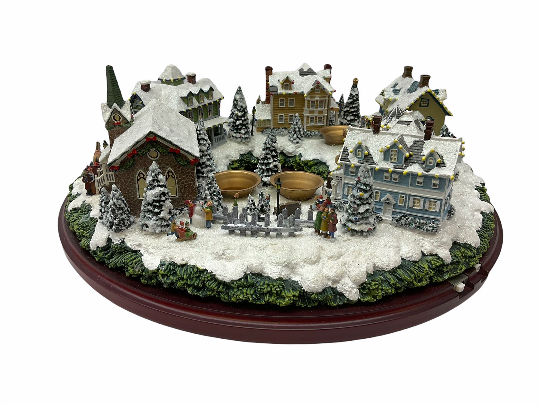 A collection of illuminating Christmas decorations, including Hawthorne Village decorations by Thomas Kinkade, Candle holders Winter Wonderland, a wreath candleholders Holiday Gathering, Village Christmas illuminated tree sculpture H39cm and Santa's on his Way, along with A Very Beary Christmas illuminated tree 33cm, and three other illuminating Christmas decorations, all with plugs. 