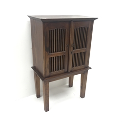 Hardwood cabinet, two doors with spindle panels, square tapering supports, W77cm, H121cm, D43cm