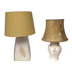 Two table lamps, to include pierced ceramic example, with gold floral shade, together with a tapering resin example, set with a leaf to each side, with fabric shade, tallest H