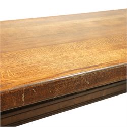 Early 20th century French oak refectory table, the thick rectangular top with cleated ends above shaped lyre-form trestle supports, united by a central stretcher, on broad scrolled feet, displaying well-figured quarter sawn grain across the top