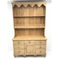 Waxed pine dresser with plate stand, projecting cornice, two shelves above six short drawers, dresser is complete with 6 short drawers and single opening cupboard, turned supports 