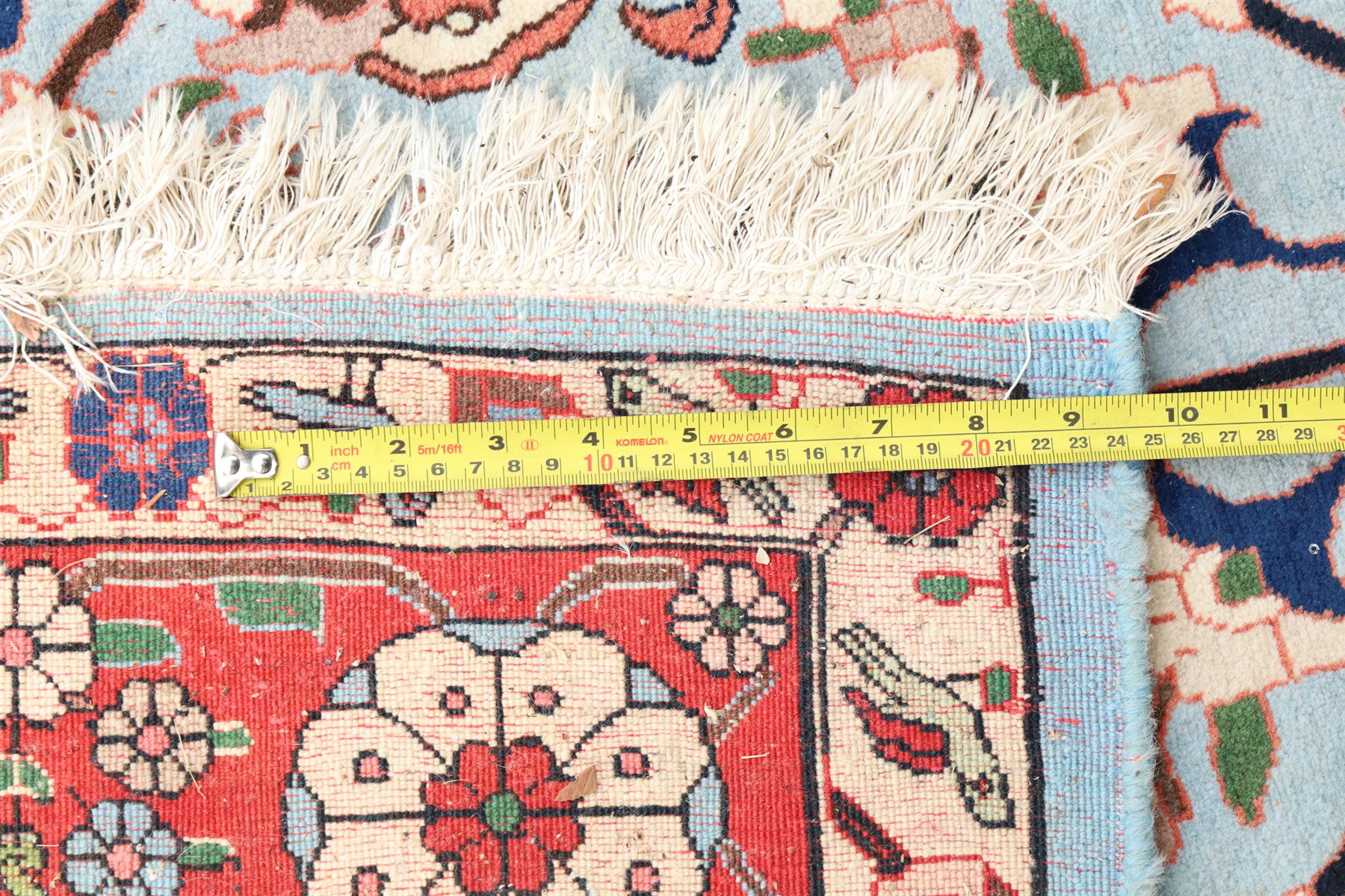 Persian Tabriz cyan ground rug of Benlian design, the field decorated with large palmette motifs, the crimson and ivory guard lines with repeating bird of paradise and interspersed stylised plant motifs