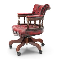 Georgian design captains swivel desk chair, rolled cresting rail over open spindle back on swivel action, upholstered in buttoned oxblood leather