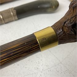 19th century painted bamboo walking cane, the handle carved as a fox with glass eyes, with gilt metal stamped LB, together with an ebonised wooden walking stick, with horn pommel and hallmarked silver collar and a curved wooden walking stick, with monogrammed white metal cap, tallest L90cm