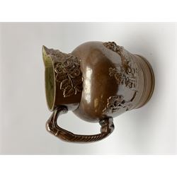 19th century salt glazed stoneware jug, with mask spout and greyhound modelled handle, the body decorated in relief with Royal Coat of Arms flanked by lions, the rim with the flowers of the union, roses, thistles and shamrocks, H26.5cm