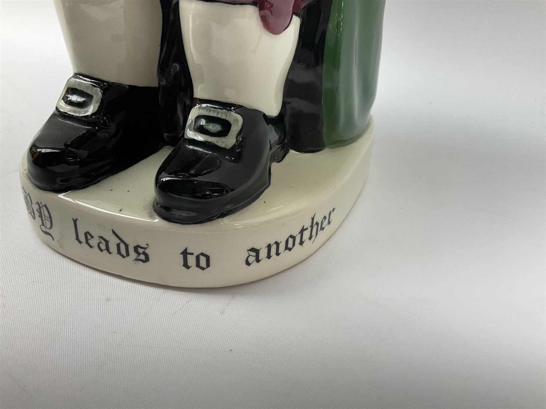 Pair of Royal Doulton Toby Ale Jugs, produced in 1934 for Charrington Ales, together with two circular metal serving trays advertising Charrington brewery, a Charrington badge awarded for 25 years of service and a 1949 menu Fox & Nicholl Ltd annual dinner dance at the toby jug hotel.  