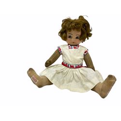 1920s Chad Valley 'Bambina' doll, the pressed felt head with applied hair, side glancing inset glass eyes, painted facial features and velvet jointed body, Hygenic and Bambina labels to the feet H46cm