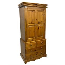 Solid stained pine double wardrobe, fitted with two panelled doors above two short and two long drawers