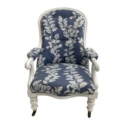 Victorian white painted open armchair, upholstered in blue fabric decorated with trailing leaf pattern, scrolled arm terminals on turned front supports with castors