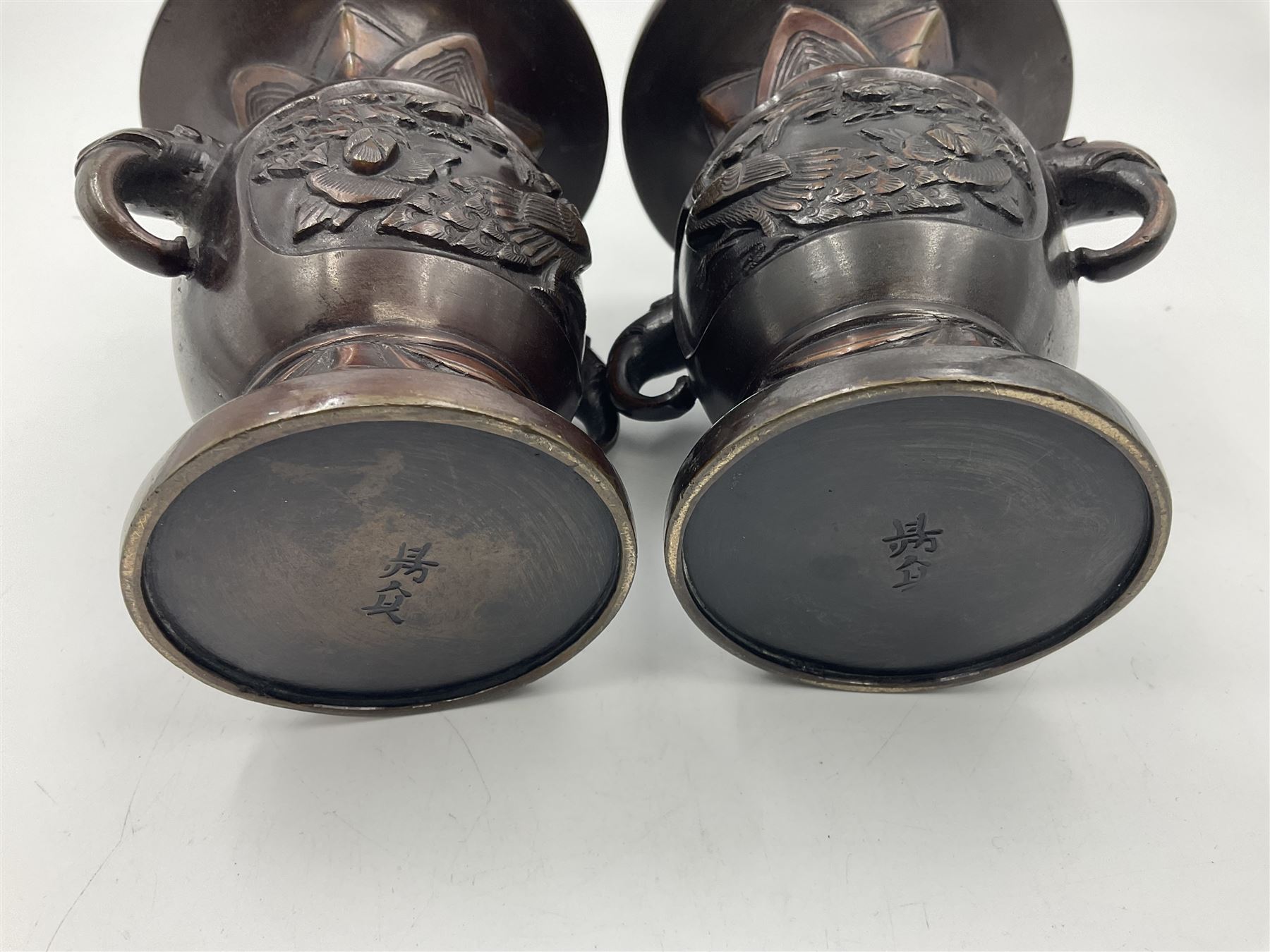 Chinese bronze vase, of baluster form with elongated neck, decorated in relief with birds amongst prunus blossom, together with a smaller pair of twin handled bronzed vases, decorated with peacocks and a blue Peking glass dish, with white metal mounted decorated with dragons, bronze vase H23.3cm