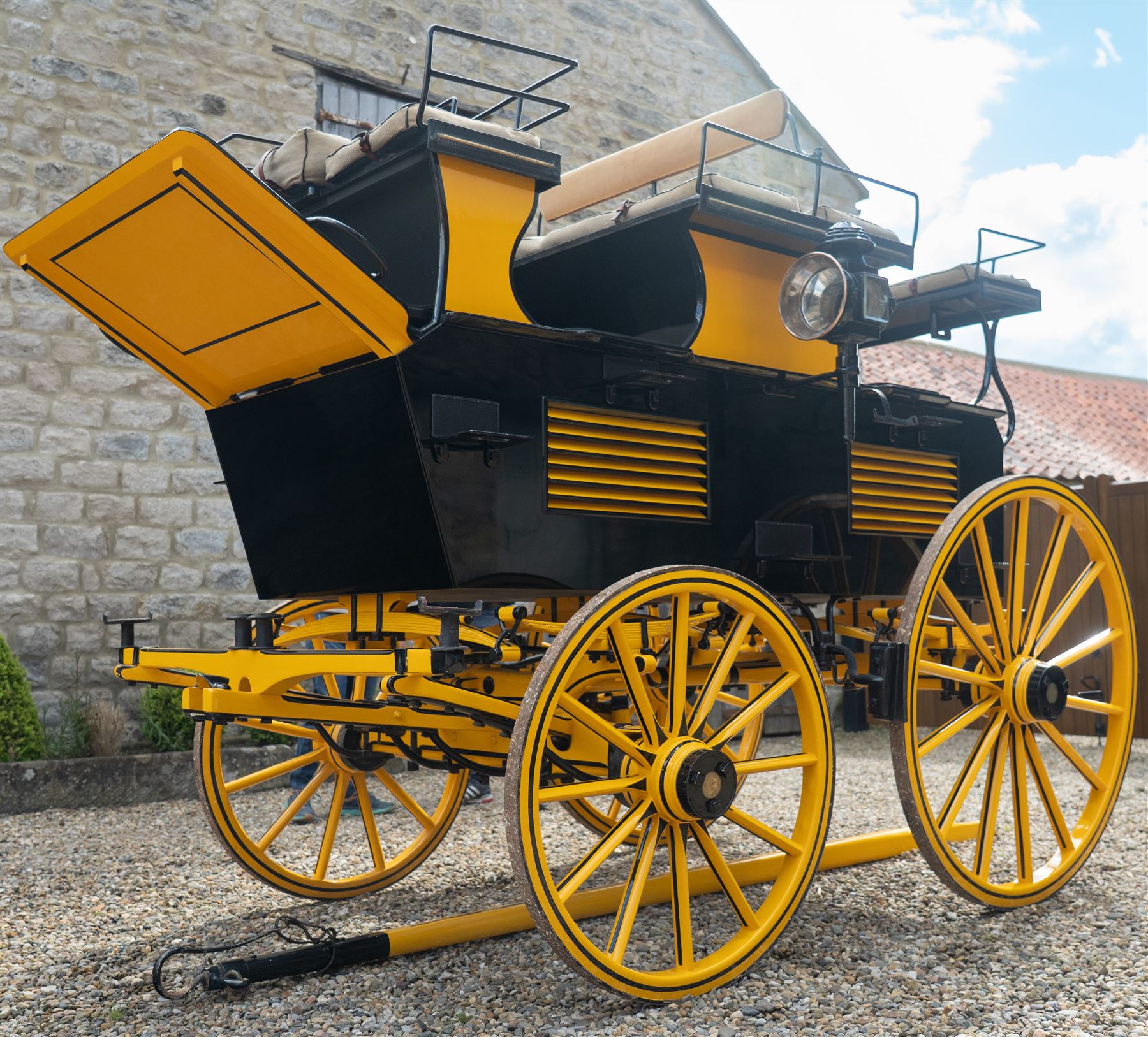 Roof Seat Break by Shanks of London

A roof seat break by Shanks of London built on a perch in black and yellow livery, the body fitted with an elevated driver's box seat, elevated rear groom's seat and central passenger compartment. The carriage is mounted on wooden spoked wheels with leaf spring suspension and is equipped with louvred underbody storage compartments, carriage lamp brackets (lamps next lot), folding access steps and a pole for driving with a pair or team of horses. The wheel hubs are stamped 