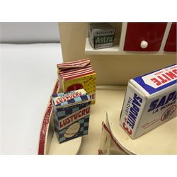 Late 1950s continental red and white painted wooden diorama of a grocery shop interior with fitted shelves and drawers and freestanding 'glazed' counter, fully stocked with miniature tin cans and packets of food L42cm H23cm D22cm