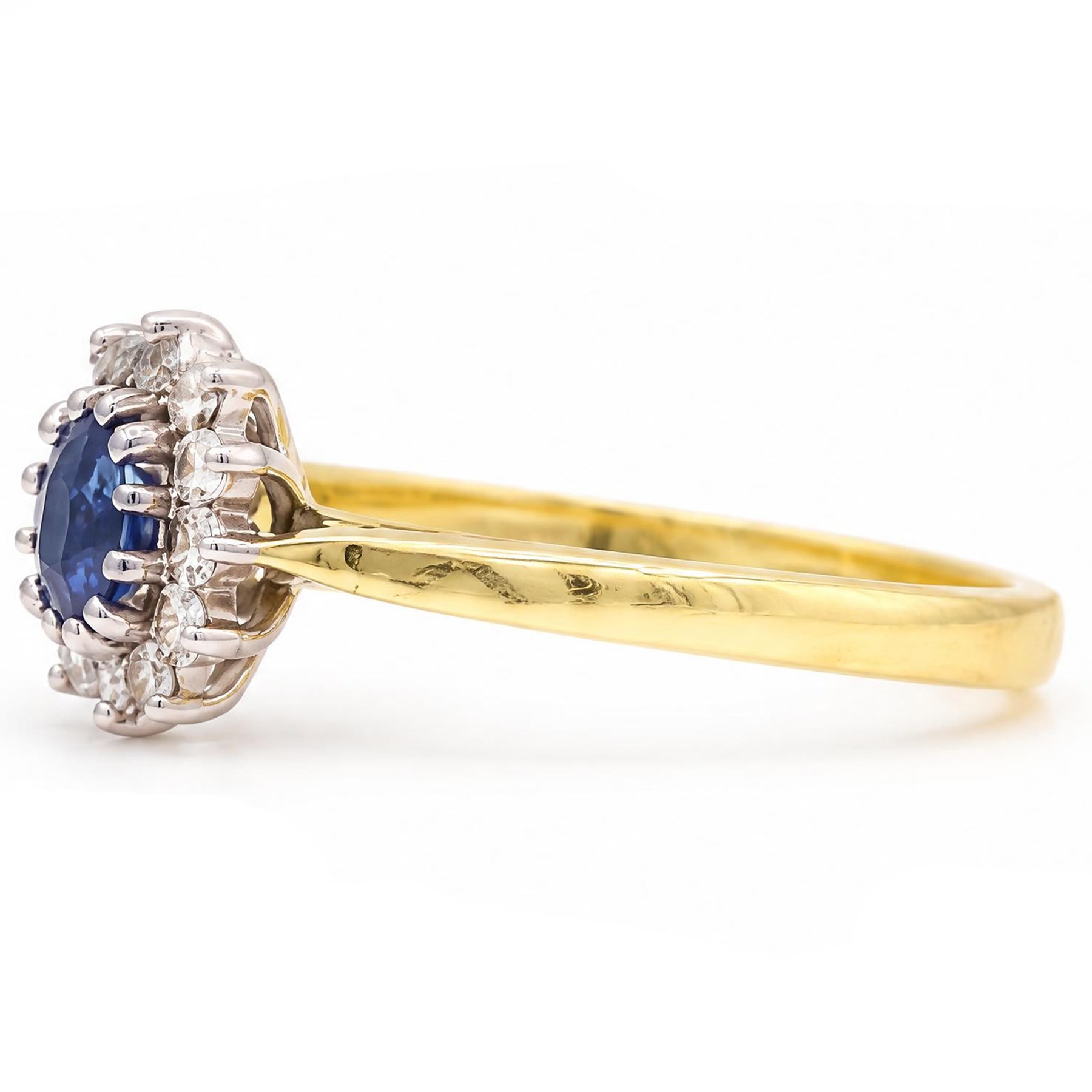 18ct gold sapphire and diamond cluster ring, single oval cut sapphire of approx 0.45 carat, surrounded by twelve round brilliant cut diamonds, London 1998, total diamond weight approx 0.25 carat