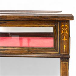 Edwardian rosewood bijouterie cabinet, the hinged rectangular top with line inlay enclosing a velvet lined interior, upon slender tapering legs inlaid with satinwood foliate marquetry decoration, with stretchers united by an under tier, raised on castors 