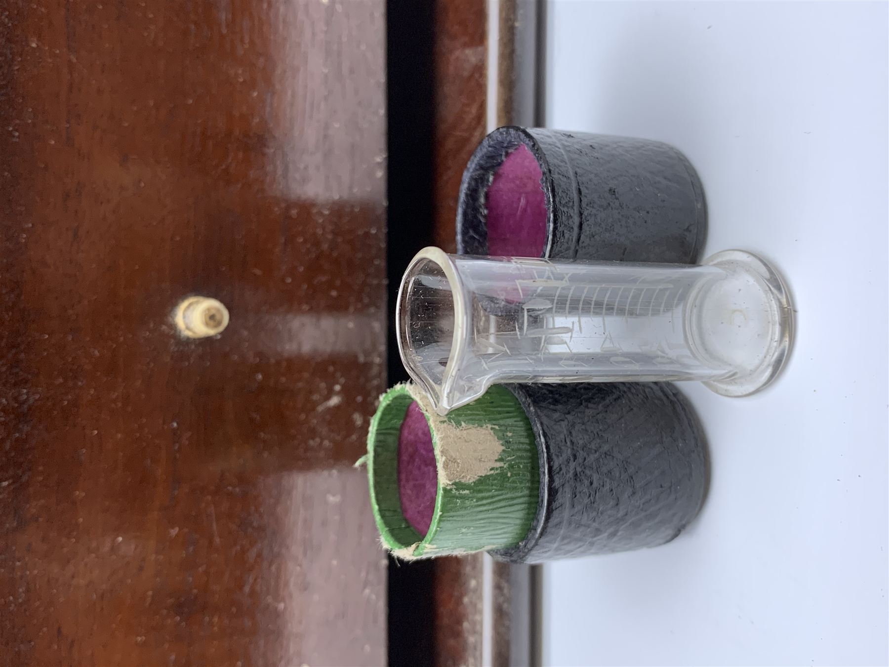 19th century mahogany travelling apothecary cabinet, with recessed brass carry handle to top, and two deep-section hinged doors to the front opening to reveal a fitted interior with clear glass bottles and two drawers, H27cm