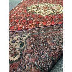 Persian red ground runner rug, central pale floral medallion and corners, floral and shaped field