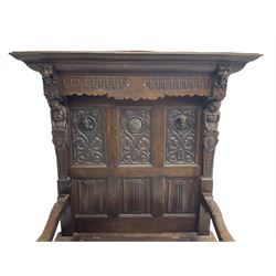 19th century and later carved oak hall bench or settle, the projecting moulded canopy top over triple panelled back, the back carved with masks, roundels and linenfolds, acanthus scroll carved arms with grotesque head terminals, hinged box seat over panelled front