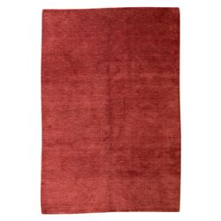 Modern Gabbeh red wool rug, plain madder red field with subtle tonal variation and abrash