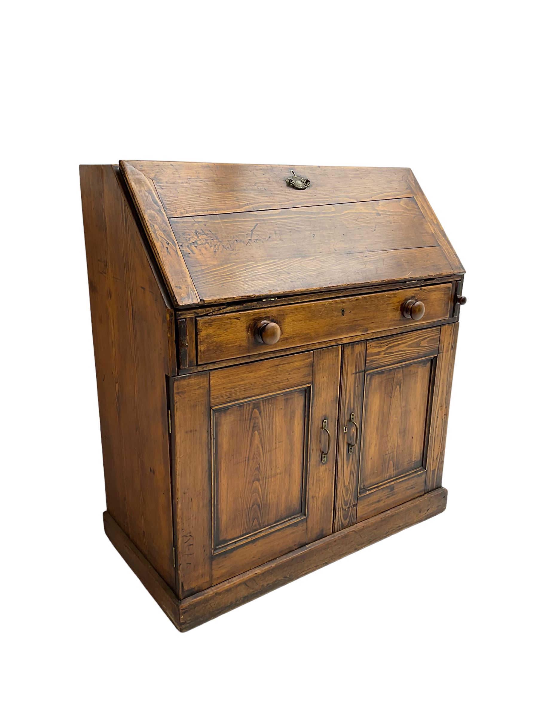 19th century waxed pine bureau, the fall front opening to reveal fitted interior with two drawers and five pigeonholes, base with single drawer over two panelled cupboard doors, on plinth base