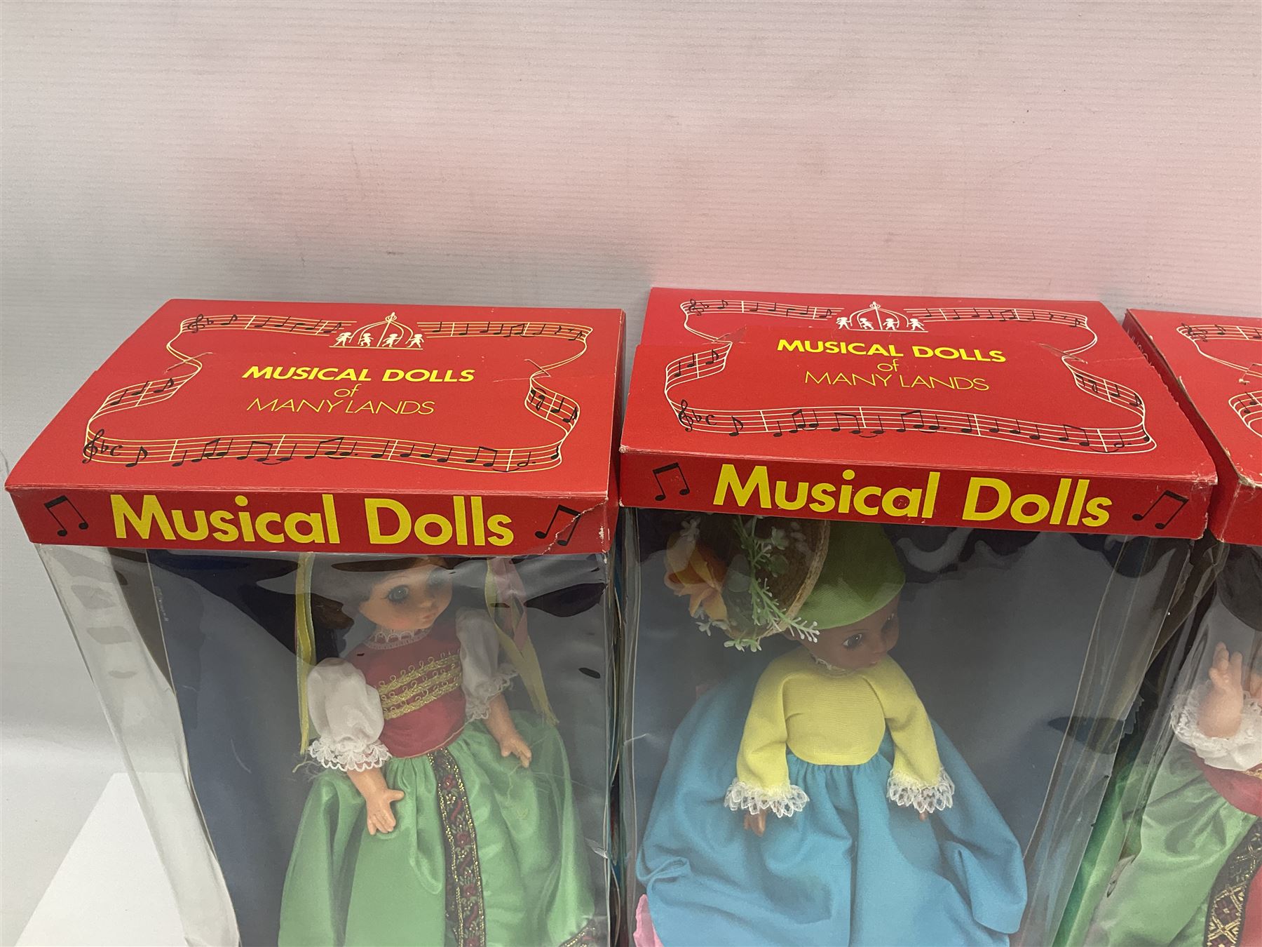 Four Mayfair Products Musical Dolls of Many Lands; original boxes and delivery boxes; and set of twelve Nationality Dolls with Sleeping Eyes; boxed (16)