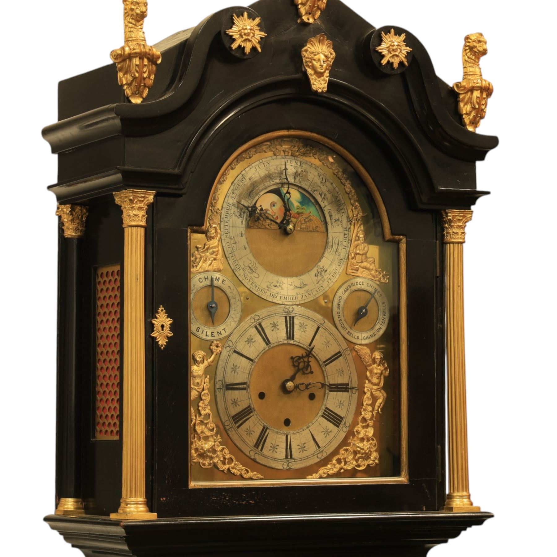 Late nineteenth century ebonised and gilt-bronze mounted musical longcase clock of impressive architectural form, the case of ebonised finish with applied gilt bronze neoclassical inspired masks and mounts, hood of arched form with glazed door, flanked by free fluted columns with gilt bronze Corinthian capitals surmounted by stylized Lion finials, frieze and arch enriched with applied foliate mounts, trunk with a rectangular glazed door bordered by mouldings and flanked by engaged columns with gilt bronze mounts above a shaped projecting base panel with applied central female mask and corner foliate ornamentation, arched brass dial, with a silvered chapter ring and applied cast gilt bronze spandrels and arch decoration, incorporating subsidiary selection dials for chime/silent and tune regulation, offering Cambridge chimes on eight bells and an additional chime sequence on ten bells, brass arch is further embellished with a moon phase aperture with lunar calendar scale, Zodiac symbols, month and date indication on a silvered dial, substantial eight-day, three-train movement with pinned cylinder musical train and a graduated nest of eleven bells with eleven hammers, quarter chiming with separate hour/half-hour strike and chime repetition, movement is regulated by an anchor escapement, with brass disc pendulum, three brass weights, two winding keys and case door key