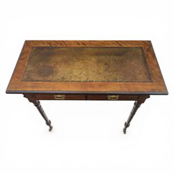 Edwardian mahogany writing table, tooled leather top over two frieze drawers, on turned supports terminating in castors
