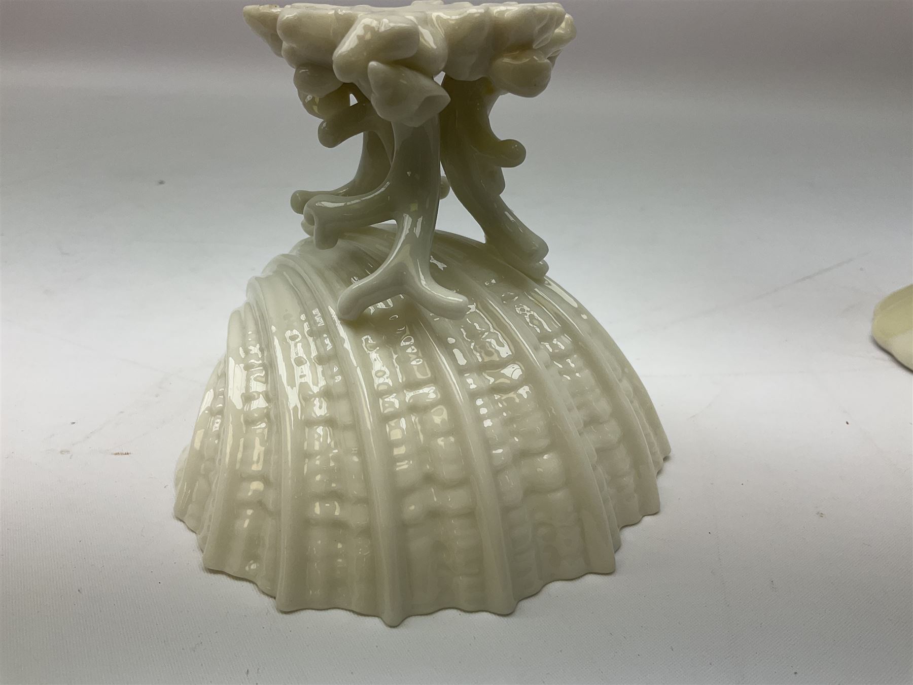 Quantity of Belleek ceramics to include mid-late 19th century jug moulded with green man mask and foliage, date code stamp for 1863-1890, together with later Belleek cornucopia shape vase, jug and other vases together with a Belleek style shell dish raised on branches, tallest H19cm