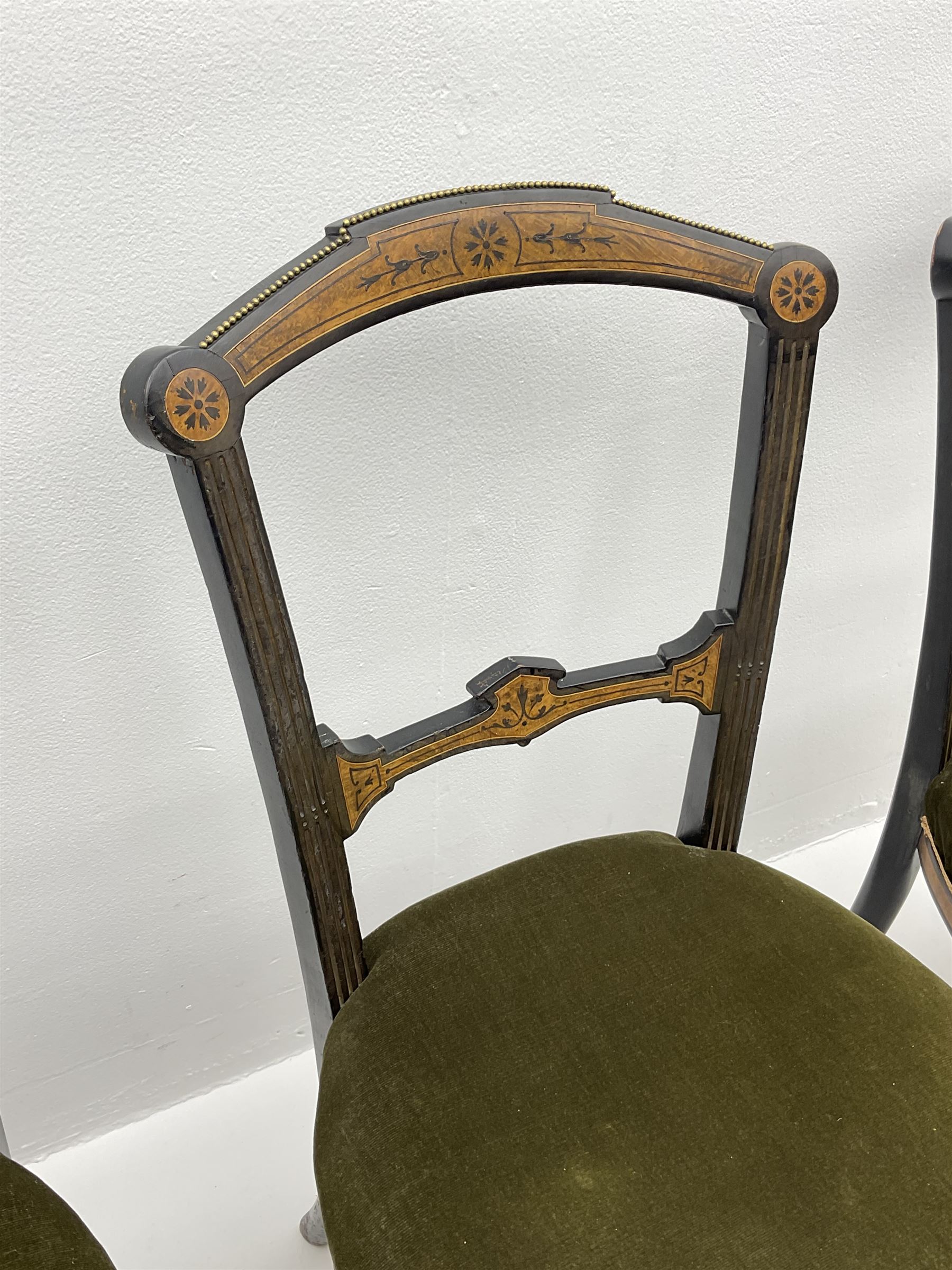 Set three late Victorian salon side chairs, ebonised frames inlaid with amboyna wood, with applied brass beading, turned and fluted supports with gilt detail