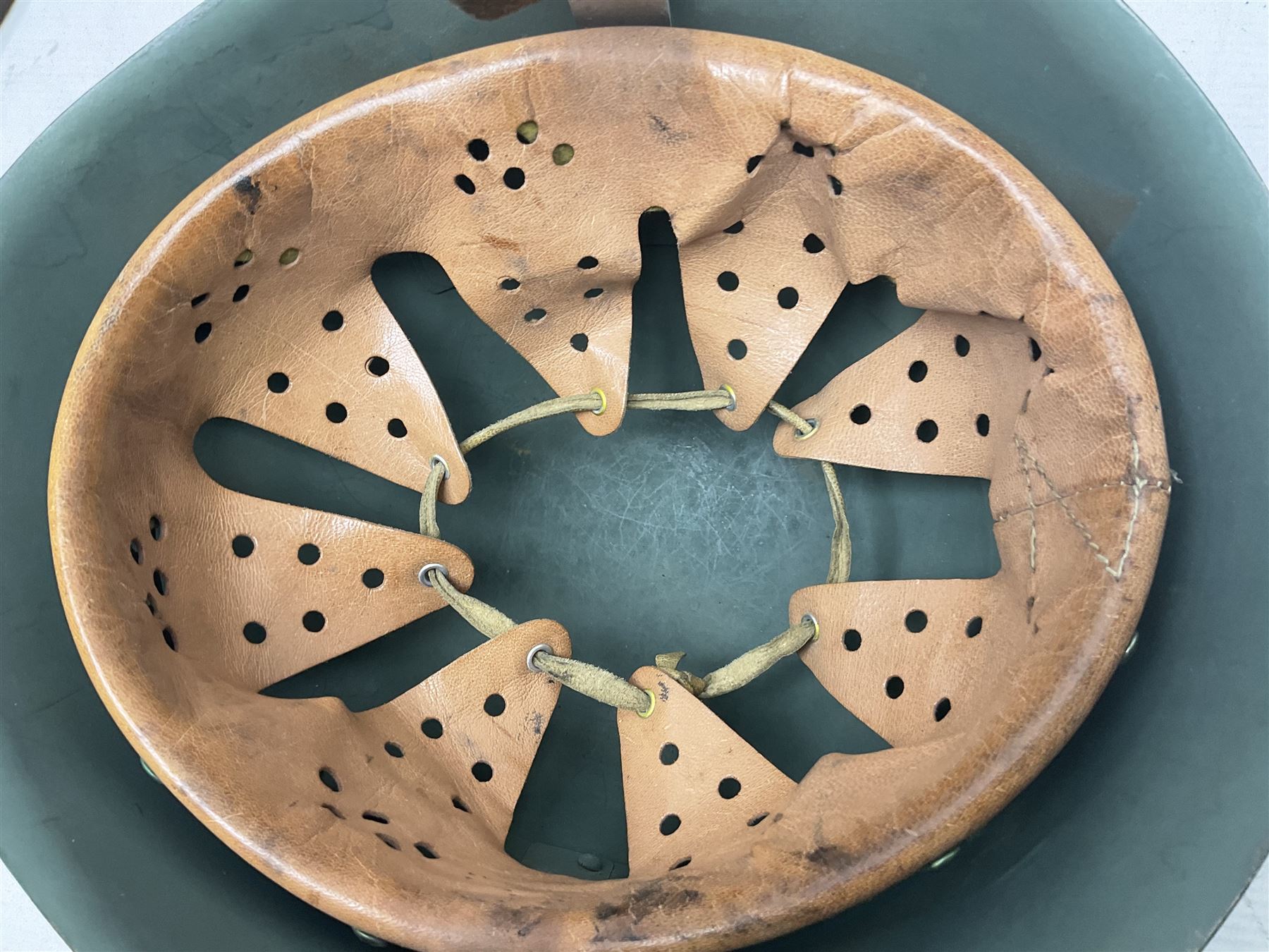 1960s Italian parachutist helmet with liner; camouflage paintwork with parachutist crest to the front